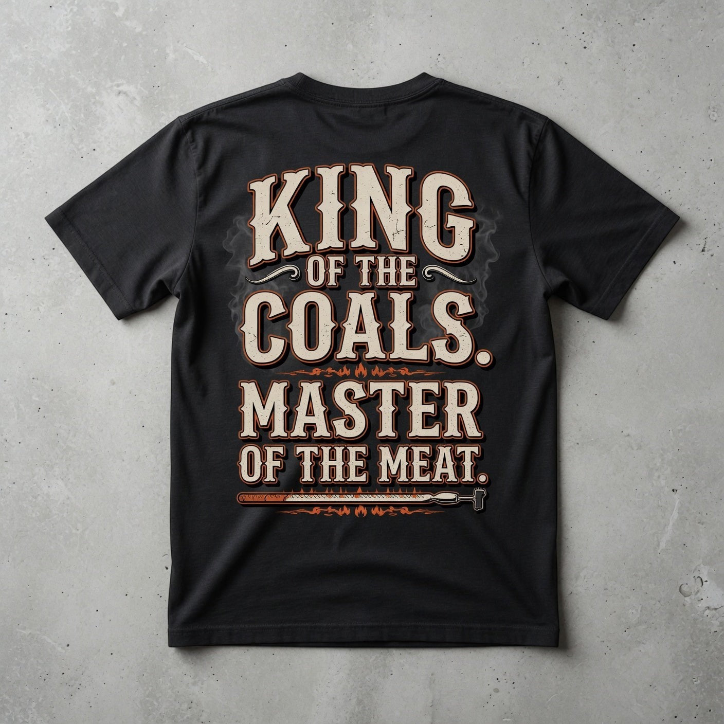 TrendyShift.Com black cotton t-shirt featuring King of the Coals Master of the Meat barbecue graphic on the back