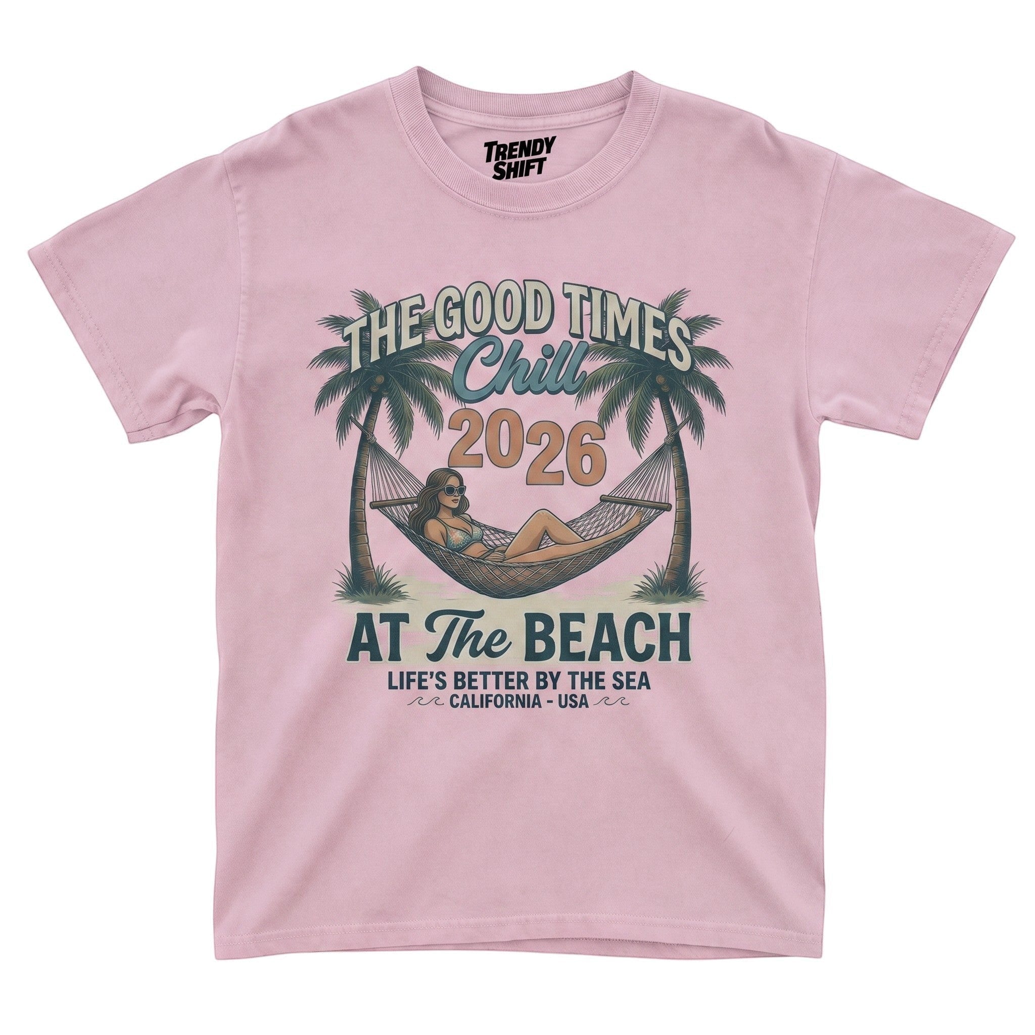 TrendyShift.Com light pink graphic t-shirt featuring a retro beach hammock scene with palm trees and summer text.